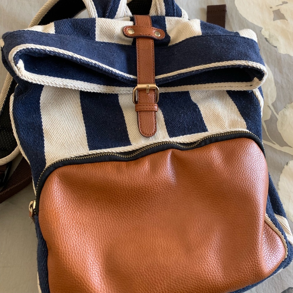 Striped backpack with leather pocket